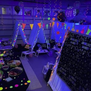 A Texas party rental room decorated with neon lights and balloons.