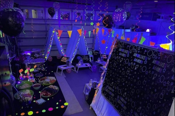 A Texas party rental room decorated with neon lights and balloons.