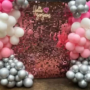A party rental photo booth with pink and silver balloons in Texas.