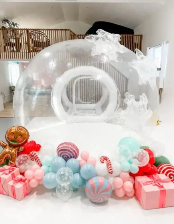 An enchanting bubble house rental with candy canes and balloons.
