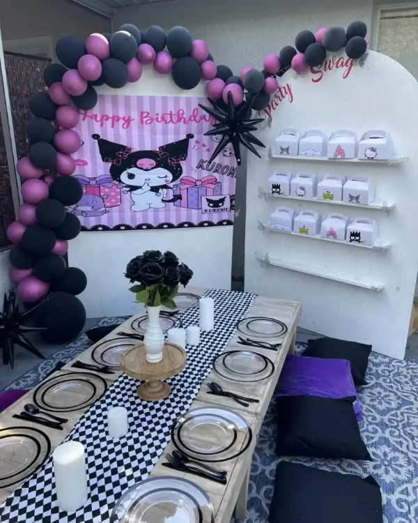 A table set up for a birthday party with black and pink balloons, available through our Texas party rental service.