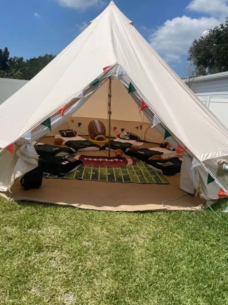 A large white party rental tent is set up in a grassy area in Texas.