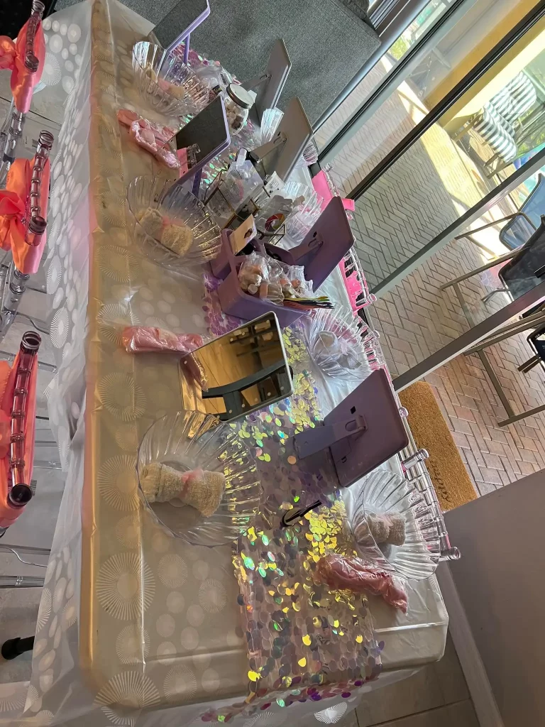 A table set up with pink and purple decorations for a Texas party rental.