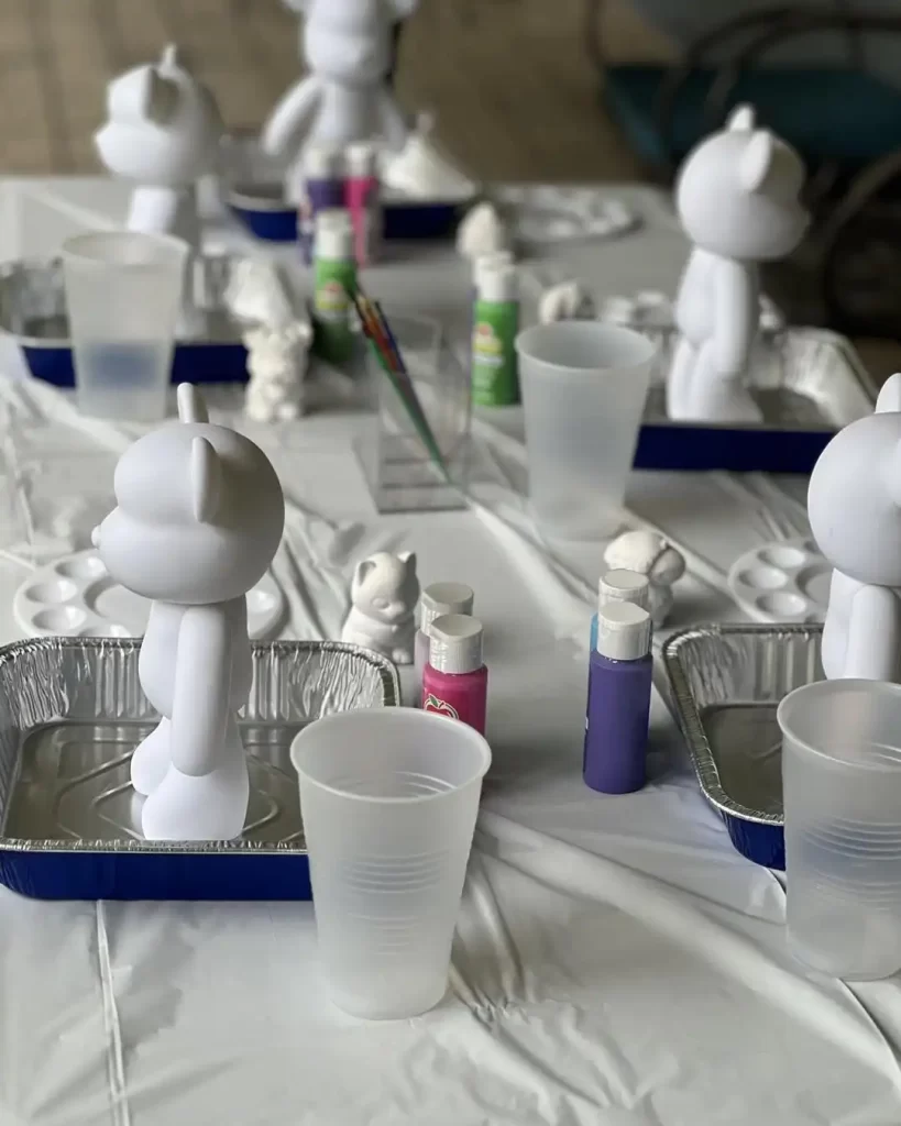 A table full of white teddy bears on a party rental table in Texas.