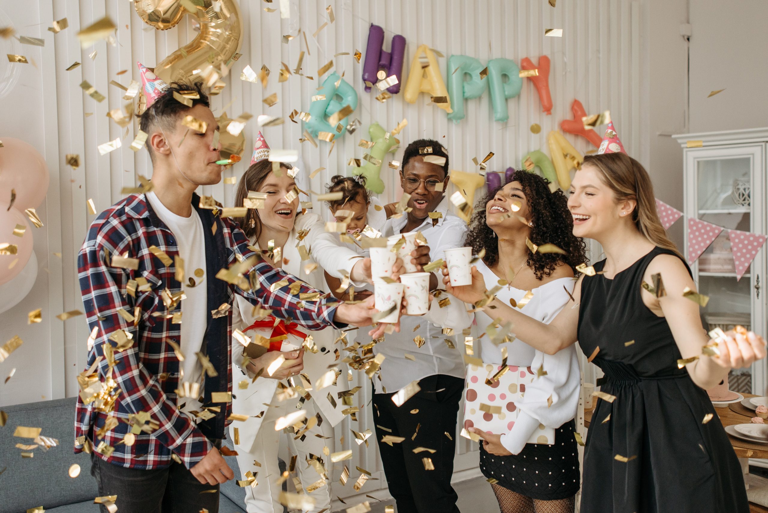 A group of friends celebrating a birthday with confetti at a Texas party rental.