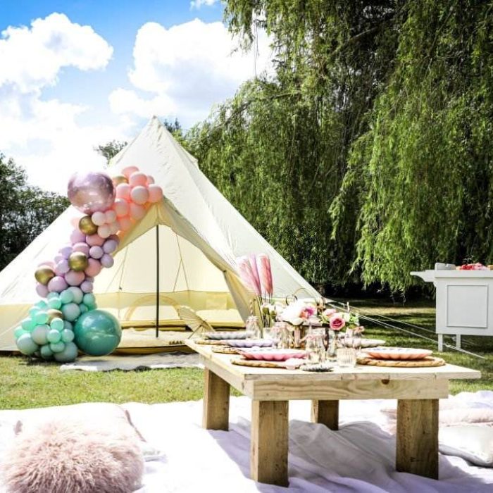 A Texas-themed teepee tent with balloons and a picnic table, available for party rental.
