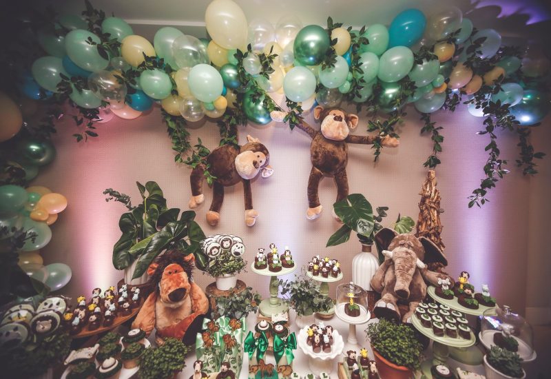A jungle-themed birthday party with balloons, monkeys, and party rental services in Texas.