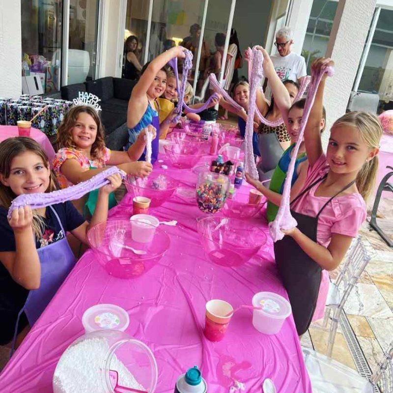 A group of girls at a Texas-themed party rental with pink tables and balloons.